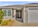 Front entrance with a stylish door and sidelights, showcasing curb appeal at 4063 Deskin Ln, The Villages, FL 32163