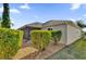 Tan house exterior with landscaped yard and screened patio at 4063 Deskin Ln, The Villages, FL 32163