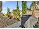 Small patio area with grill and decorative fountain at 4063 Deskin Ln, The Villages, FL 32163