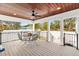 Relaxing outdoor deck with table and chairs, offering a view of the backyard at 4777 Cr 306A, Lake Panasoffkee, FL 33538