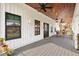 Modern farmhouse porch with black door and white siding at 4777 Cr 306A, Lake Panasoffkee, FL 33538