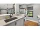 Modern kitchen with white quartz countertops and a farmhouse sink at 4777 Cr 306A, Lake Panasoffkee, FL 33538