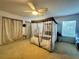 Bedroom with canopy bed and gold curtains at 5036 Gandross Ln, Mount Dora, FL 32757