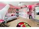 Pink bedroom with bed, closet, and colorful decor at 5036 Gandross Ln, Mount Dora, FL 32757