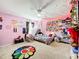 Pink bedroom with bed, closet, and colorful decor at 5036 Gandross Ln, Mount Dora, FL 32757