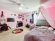 Pink bedroom with a bed, TV, and musical instruments at 5036 Gandross Ln, Mount Dora, FL 32757