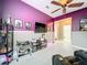 Bonus room with purple walls, large TV and ample storage at 5036 Gandross Ln, Mount Dora, FL 32757