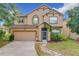 Two-story house with a landscaped lawn, stone pathway, and attached garage at 5036 Gandross Ln, Mount Dora, FL 32757