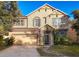 Tan two-story house with a two-car garage and landscaped yard at 5036 Gandross Ln, Mount Dora, FL 32757