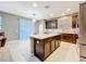 Modern kitchen with dark wood cabinets and a large island at 5036 Gandross Ln, Mount Dora, FL 32757