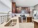 Kitchen with dark wood cabinets, white quartz countertops and mosaic backsplash at 5036 Gandross Ln, Mount Dora, FL 32757