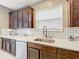 Modern kitchen with white countertops, stainless steel sink, and dark wood cabinets at 5036 Gandross Ln, Mount Dora, FL 32757