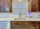 Kitchen with stainless steel sink and dark wood cabinets at 5036 Gandross Ln, Mount Dora, FL 32757