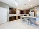 Spacious kitchen featuring dark wood cabinets and an island at 5036 Gandross Ln, Mount Dora, FL 32757