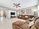 Open concept living room with sectional sofa and hardwood floors at 5036 Gandross Ln, Mount Dora, FL 32757