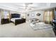 Large main bedroom with a king-size bed and sitting area at 5036 Gandross Ln, Mount Dora, FL 32757