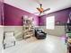 Home office with purple walls, hardwood floors, and rolling shelving unit at 5036 Gandross Ln, Mount Dora, FL 32757