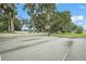 Outdoor basketball court with markings and hoop, surrounded by mature trees at 5046 Harbour Dr, Oxford, FL 34484