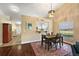 Dining area with hardwood floor, chandelier, and view of kitchen and hallway at 5046 Harbour Dr, Oxford, FL 34484