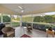 Relaxing screened porch with wicker furniture at 5046 Harbour Dr, Oxford, FL 34484