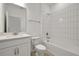 Modern bathroom with white subway tile shower, white vanity and hardware, toilet and mirror at 5095 Firebush Dr, Apopka, FL 32712