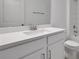 Close up of modern bathroom sink with white countertop, toilet, shower and mirror at 5095 Firebush Dr, Apopka, FL 32712