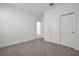 Bright bedroom with carpet floors and sliding door closet, with the door open leading to the rest of the home at 5095 Firebush Dr, Apopka, FL 32712