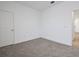 Bright bedroom with carpet floors, white walls and baseboards and a door leading to the rest of the home at 5095 Firebush Dr, Apopka, FL 32712