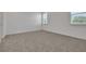 Comfortable carpeted bedroom providing a relaxing space with natural light from the large window at 5095 Firebush Dr, Apopka, FL 32712