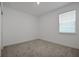 Bright bedroom featuring plush carpet, large window and a ceiling light at 5095 Firebush Dr, Apopka, FL 32712