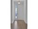 Welcoming entryway featuring wood floors and a bright atmosphere, leading into the rest of the home at 5095 Firebush Dr, Apopka, FL 32712