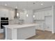 A sleek and modern kitchen with white cabinets, stainless steel appliances, and an island at 5095 Firebush Dr, Apopka, FL 32712
