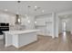 Kitchen with white cabinets, granite countertops, pendant lights and stainless steel appliances at 5095 Firebush Dr, Apopka, FL 32712