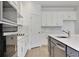 Modern kitchen featuring stainless steel appliances, granite countertops and sleek, white cabinetry at 5095 Firebush Dr, Apopka, FL 32712