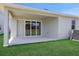 Covered patio provides an ideal spot for outdoor seating and entertaining with a view of the yard at 5095 Firebush Dr, Apopka, FL 32712