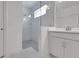 Modern bathroom featuring a glass-enclosed shower with marble tile and a vanity with sleek fixtures at 5131 Firebush Dr, Apopka, FL 32712