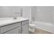 Bright bathroom featuring gray cabinets, white countertops, subway tile, and wood-look tile flooring at 5131 Firebush Dr, Apopka, FL 32712