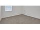 Cozy carpeted bedroom with white trim, walls, baseboards, and a window with blinds for a clean, modern look at 5131 Firebush Dr, Apopka, FL 32712