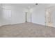 Neutral bedroom with carpet flooring, white walls, and two doors leading to other parts of the house at 5131 Firebush Dr, Apopka, FL 32712