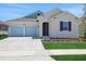 Charming single-Gathering home with a two-car garage and well-maintained landscaping at 5131 Firebush Dr, Apopka, FL 32712