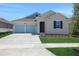 Charming single-Gathering home with a two-car garage and well-maintained landscaping at 5131 Firebush Dr, Apopka, FL 32712