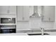 Kitchen showcasing gray cabinets, stainless steel appliances, and a stylish tile backsplash at 5131 Firebush Dr, Apopka, FL 32712