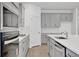 Modern kitchen features gray cabinets, stainless steel appliances, and quartz countertops at 5131 Firebush Dr, Apopka, FL 32712