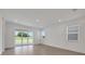Bright living room featuring tile flooring, large sliding glass doors, and natural light at 5131 Firebush Dr, Apopka, FL 32712