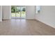 Bright living room featuring tile flooring, large sliding glass doors, and natural light at 5131 Firebush Dr, Apopka, FL 32712