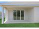 Covered patio with sliding glass doors, perfect for enjoying the outdoors in comfort at 5131 Firebush Dr, Apopka, FL 32712