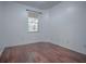 Well-lit bedroom with hardwood floors and window at 5929 Coquyt Dr, Mount Dora, FL 32757