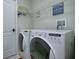 Laundry room with washer, dryer, and shelving at 5929 Coquyt Dr, Mount Dora, FL 32757