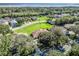 Aerial view showing home's location in a residential area near water at 6220 Topsail Rd, Lady Lake, FL 32159