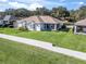 Aerial view of house, showcasing backyard and neighborhood setting at 6220 Topsail Rd, Lady Lake, FL 32159